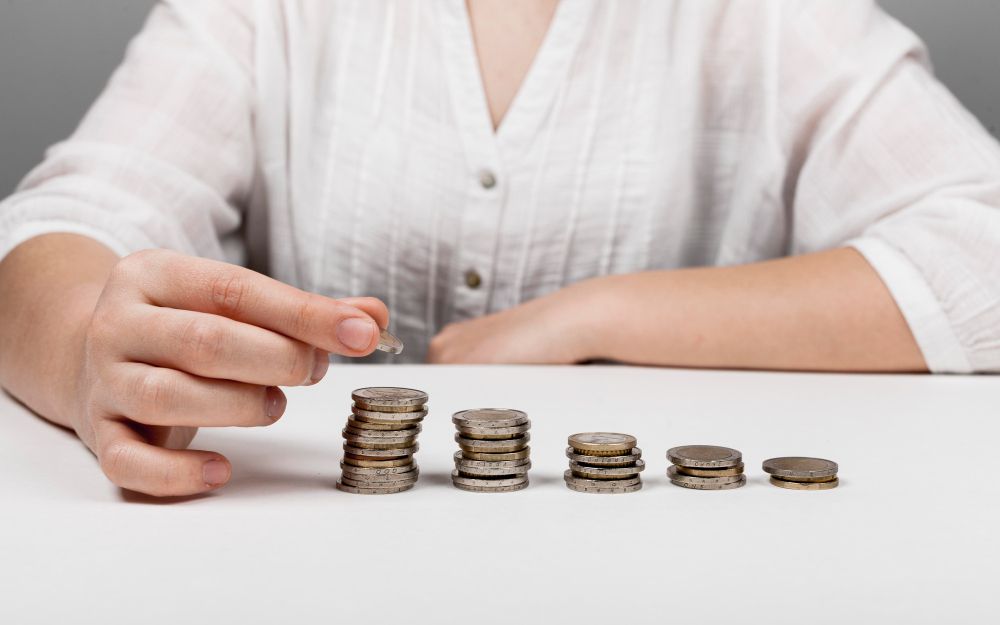 descending-piles-of-coins-and-woman.jpg